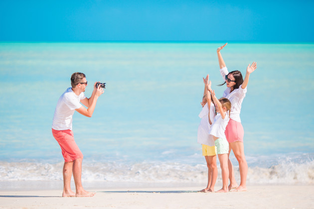 Family Of Four Taking A Selfie Photo On Their Beach