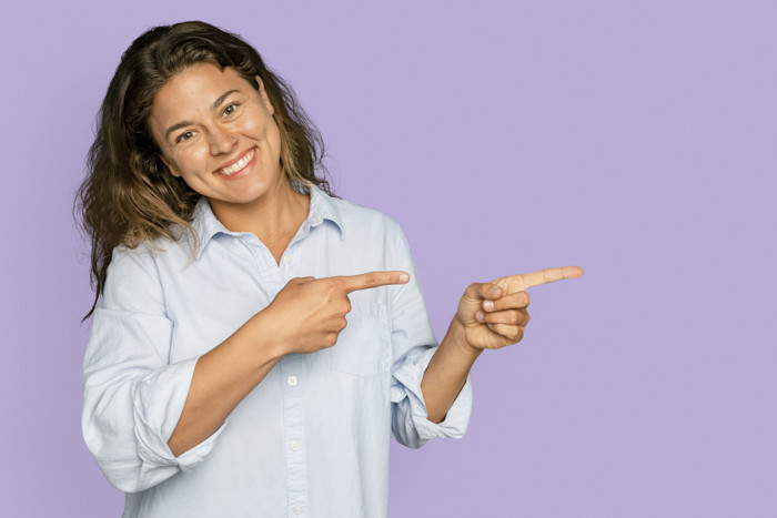 Cheerful Woman Pointing To The Side And Smiling