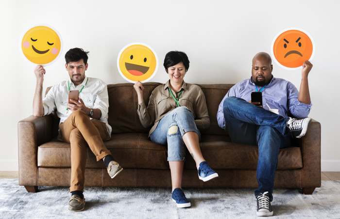 Diverse People Sitting And Holding Emojis