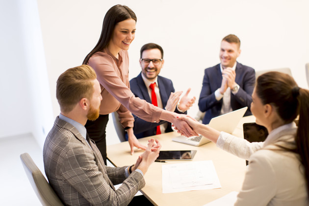 Business People Shaking Hands After Presentation