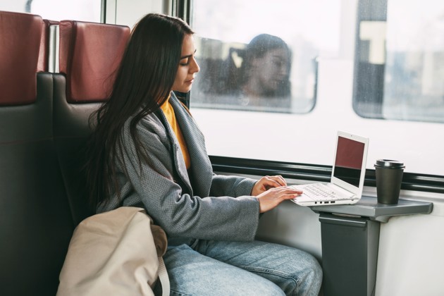 Freelance Girl Sitting On A Train With A Laptop M 2023 11 27 05 31 54 Utc